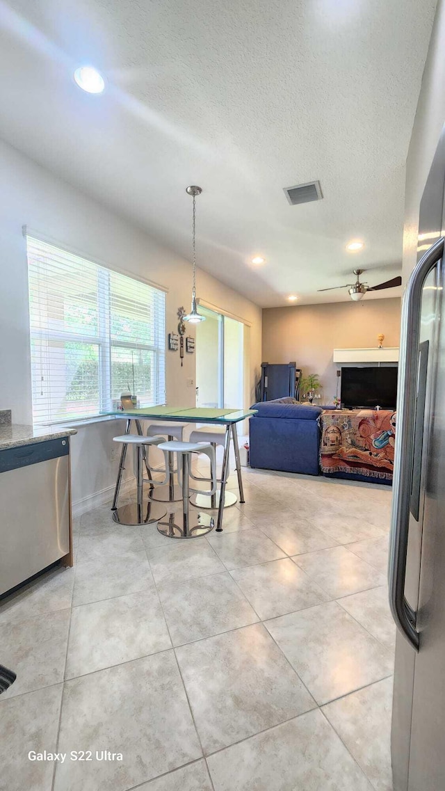 interior space with recessed lighting, visible vents, a textured ceiling, and light tile patterned floors