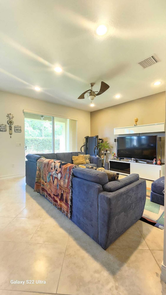 living area featuring light tile patterned flooring, recessed lighting, visible vents, and a ceiling fan