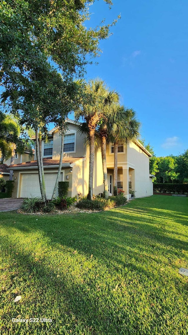 view of front of home with a front lawn and stucco siding