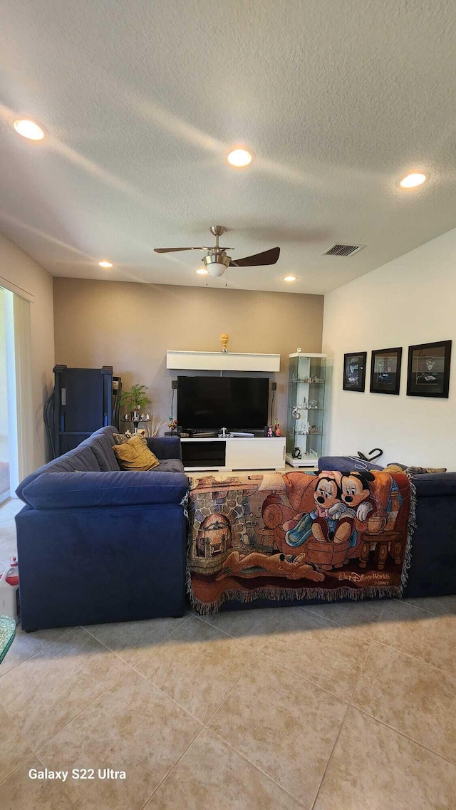 living area featuring ceiling fan, a textured ceiling, visible vents, and recessed lighting