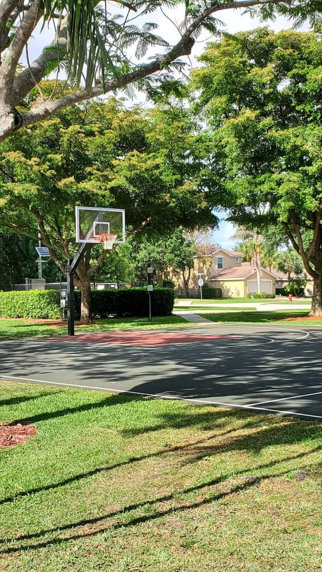 view of sport court featuring community basketball court and a yard