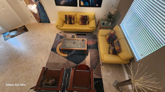 tiled living area featuring baseboards