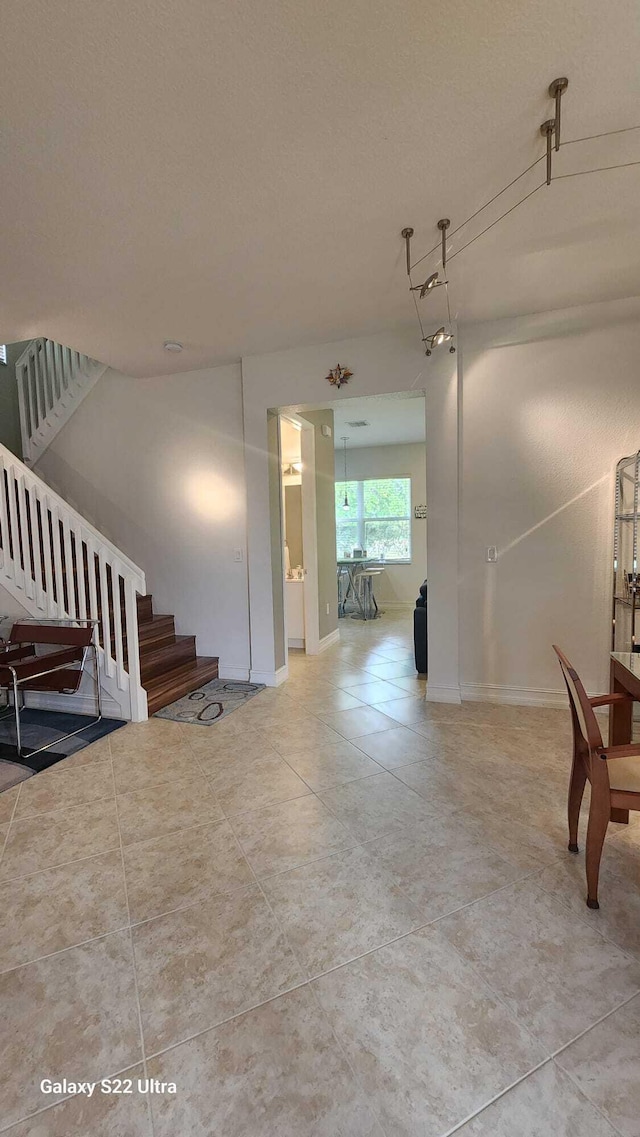 interior space featuring stairway and baseboards