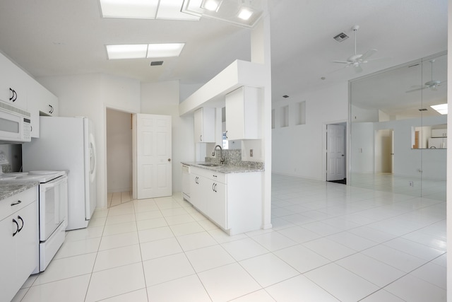 kitchen featuring light tile patterned floors, visible vents, white cabinetry, a sink, and white appliances