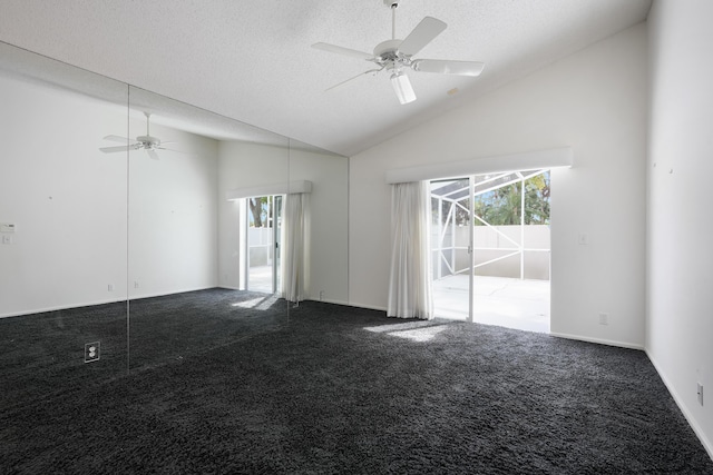 spare room with a textured ceiling, carpet floors, high vaulted ceiling, and a ceiling fan