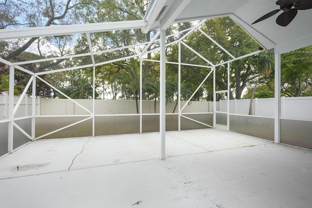 exterior space featuring a lanai, fence, and a ceiling fan