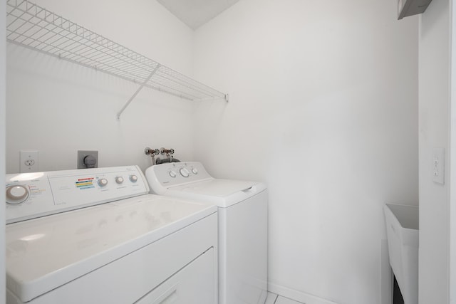 laundry room featuring washer and dryer, laundry area, and a sink