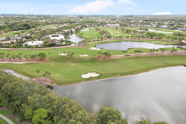 drone / aerial view with view of golf course and a water view