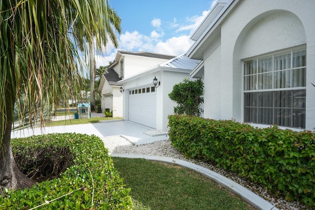 view of home's exterior featuring a garage and stucco siding