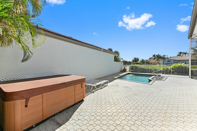 view of pool with a patio area, a jacuzzi, fence, and a fenced in pool