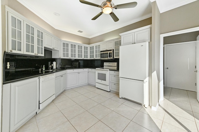 kitchen featuring dark countertops, white appliances, glass insert cabinets, and white cabinets