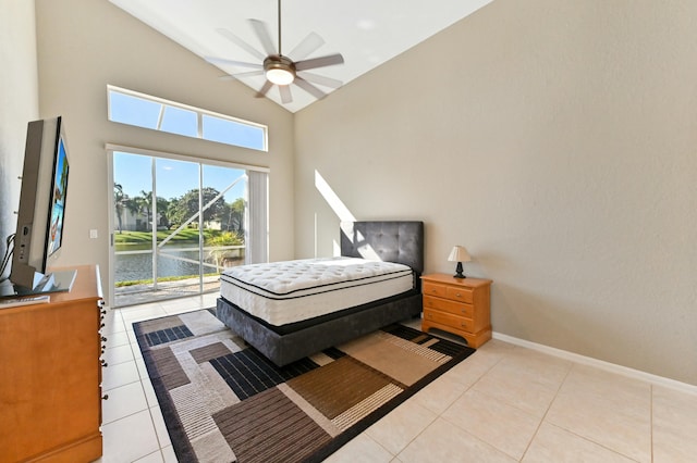 bedroom featuring light tile patterned floors, a towering ceiling, a ceiling fan, access to outside, and baseboards