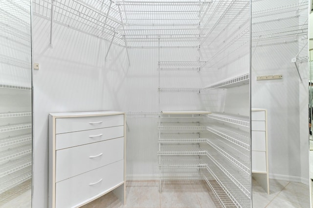 spacious closet featuring tile patterned flooring