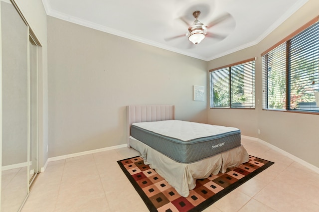 bedroom featuring crown molding, baseboards, and light tile patterned floors