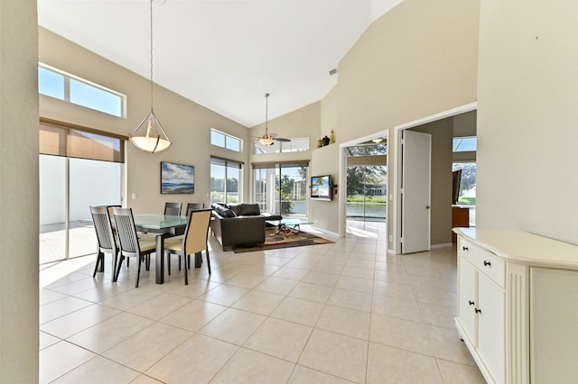 dining area with high vaulted ceiling, light tile patterned floors, baseboards, and a ceiling fan