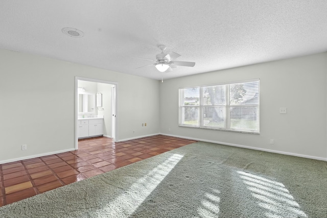 unfurnished bedroom featuring a ceiling fan, tile patterned flooring, a textured ceiling, and baseboards