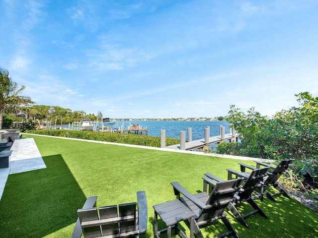 view of yard with a water view and a boat dock