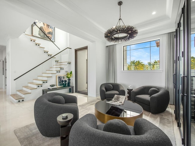 living room with recessed lighting, ornamental molding, stairs, a raised ceiling, and a notable chandelier