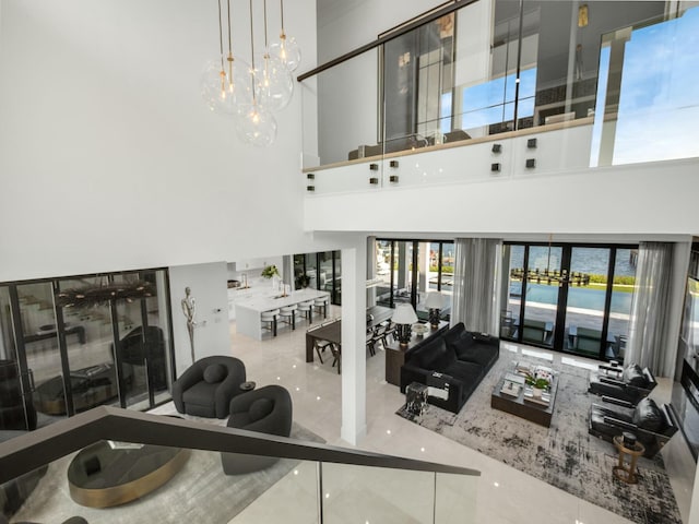 living area with a high ceiling and marble finish floor