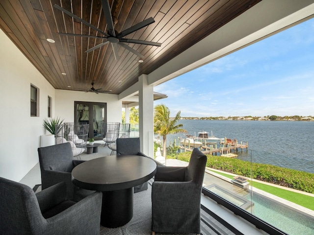 view of patio featuring outdoor dining space, french doors, a water view, and ceiling fan
