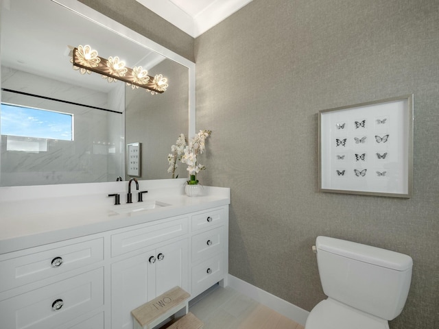 bathroom featuring a shower, baseboards, toilet, and vanity