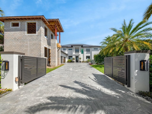 view of street featuring a gated entry, concrete driveway, and a gate