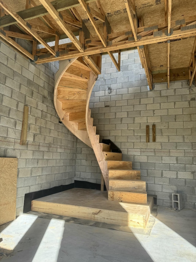 interior space with concrete block wall and concrete flooring