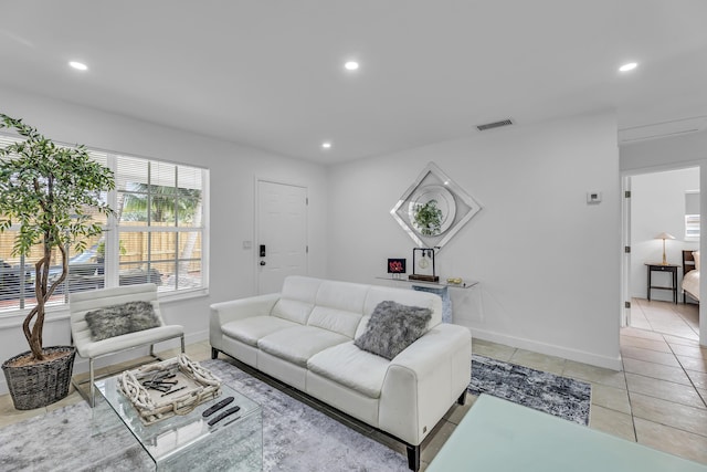 living room featuring light tile patterned floors, baseboards, visible vents, and recessed lighting