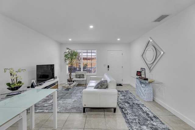 living area with recessed lighting, visible vents, baseboards, and light tile patterned flooring