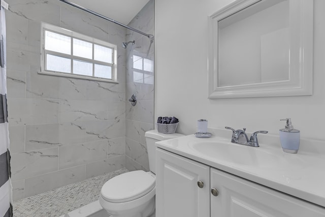 full bathroom featuring toilet, a shower stall, and vanity