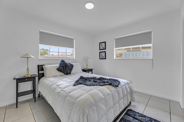 bedroom featuring baseboards and tile patterned floors