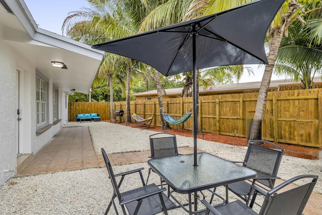 view of patio with outdoor dining space and a fenced backyard