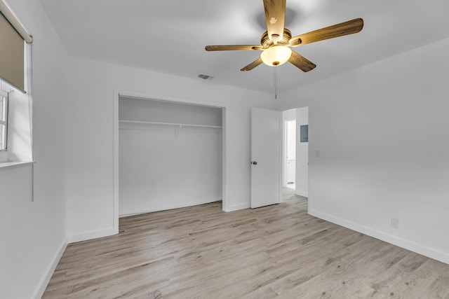 unfurnished bedroom with light wood-style floors, baseboards, visible vents, and a closet