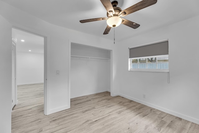 unfurnished bedroom featuring light wood-type flooring, a closet, ceiling fan, and baseboards