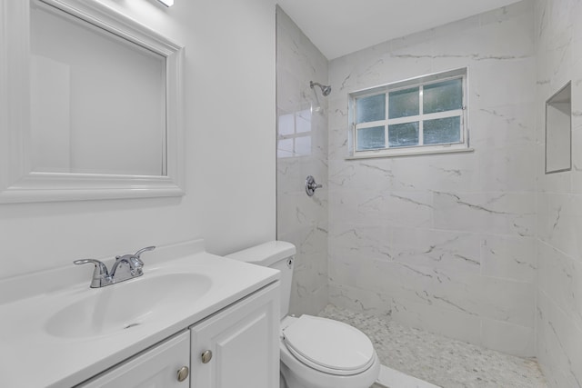 full bathroom featuring toilet, a stall shower, and vanity