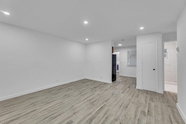 spare room with light wood-style floors, recessed lighting, and baseboards