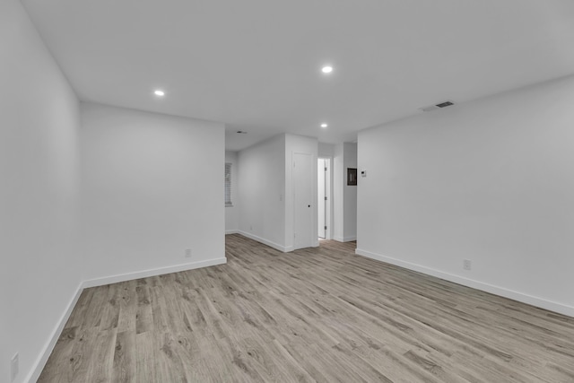 unfurnished room with baseboards, recessed lighting, visible vents, and light wood-style floors