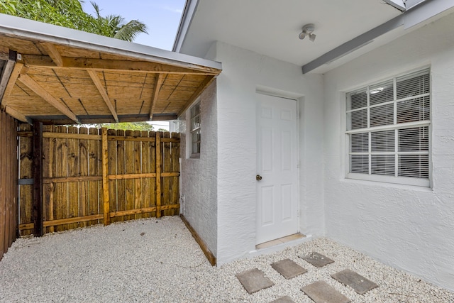 doorway to property featuring stucco siding