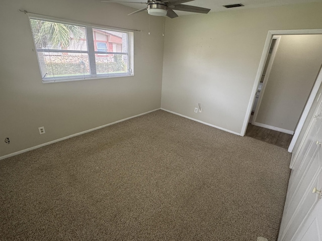 unfurnished bedroom with ceiling fan, carpet, visible vents, and baseboards