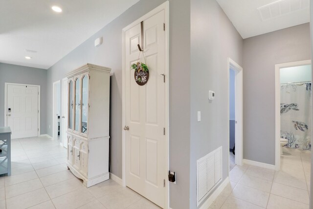 laundry area featuring separate washer and dryer, cabinet space, and baseboards