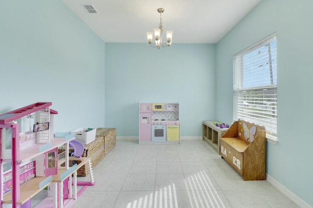 recreation room featuring tile patterned floors, a notable chandelier, visible vents, and baseboards