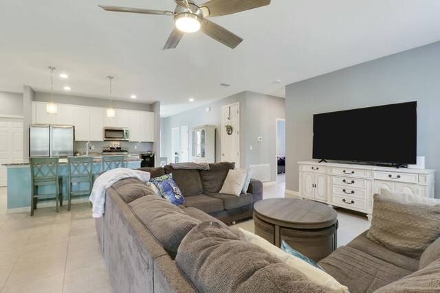 carpeted bedroom featuring baseboards and a ceiling fan