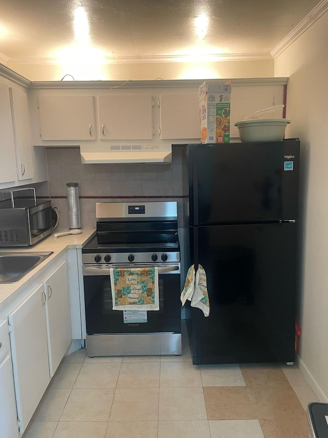 kitchen with stainless steel appliances, light countertops, white cabinets, a sink, and under cabinet range hood