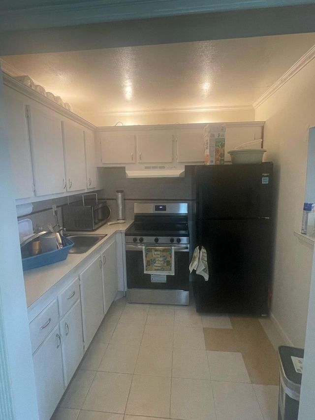 kitchen featuring under cabinet range hood, stainless steel electric range, freestanding refrigerator, and white cabinets