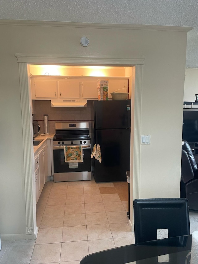 kitchen featuring white cabinets, stainless steel appliances, a textured ceiling, light countertops, and under cabinet range hood