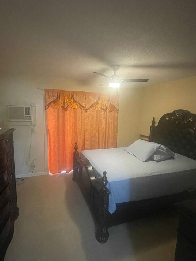 bedroom with an AC wall unit, ceiling fan, and a textured ceiling