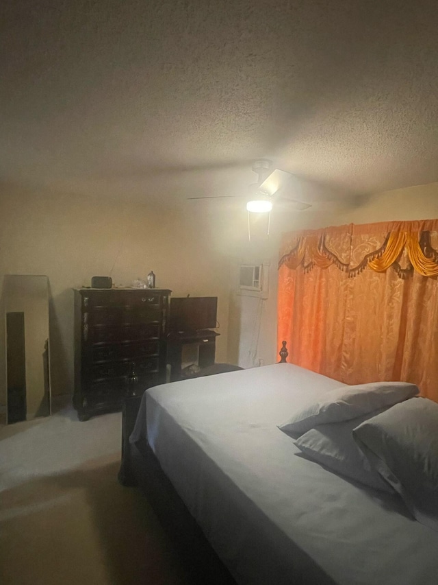 bedroom featuring a ceiling fan and a textured ceiling