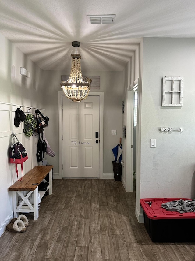 6101 NW Painted Bunting Ct, Port Saint Lucie, FL 34986 - mudroom with a chandelier, dark wood-type flooring, and baseboards