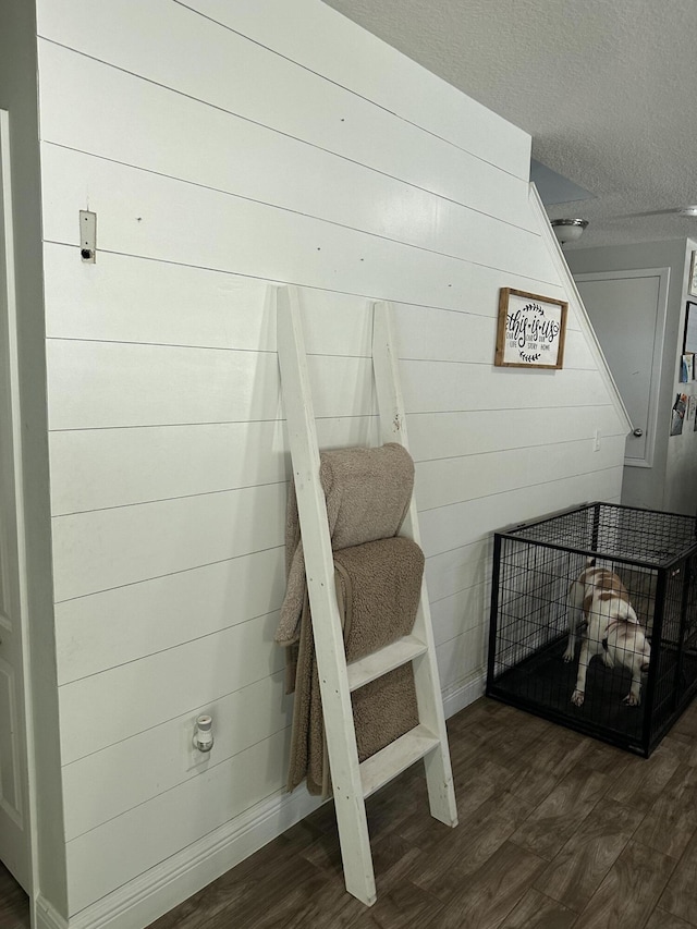 6101 NW Painted Bunting Ct, Port Saint Lucie, FL 34986 - detailed view of wood finished floors, baseboards, a textured ceiling, and wood walls