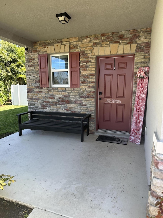 6101 NW Painted Bunting Ct, Port Saint Lucie, FL 34986 - entrance to property with stone siding and a porch